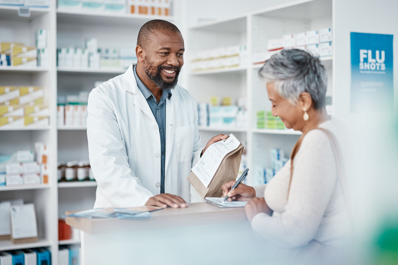 Pharmacist checking her tablet inside a pharmacy.