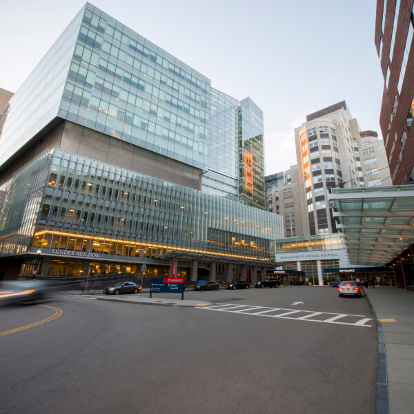 Wide shot of the exterior of the Mass General Hospital building and surrounding buildings. 