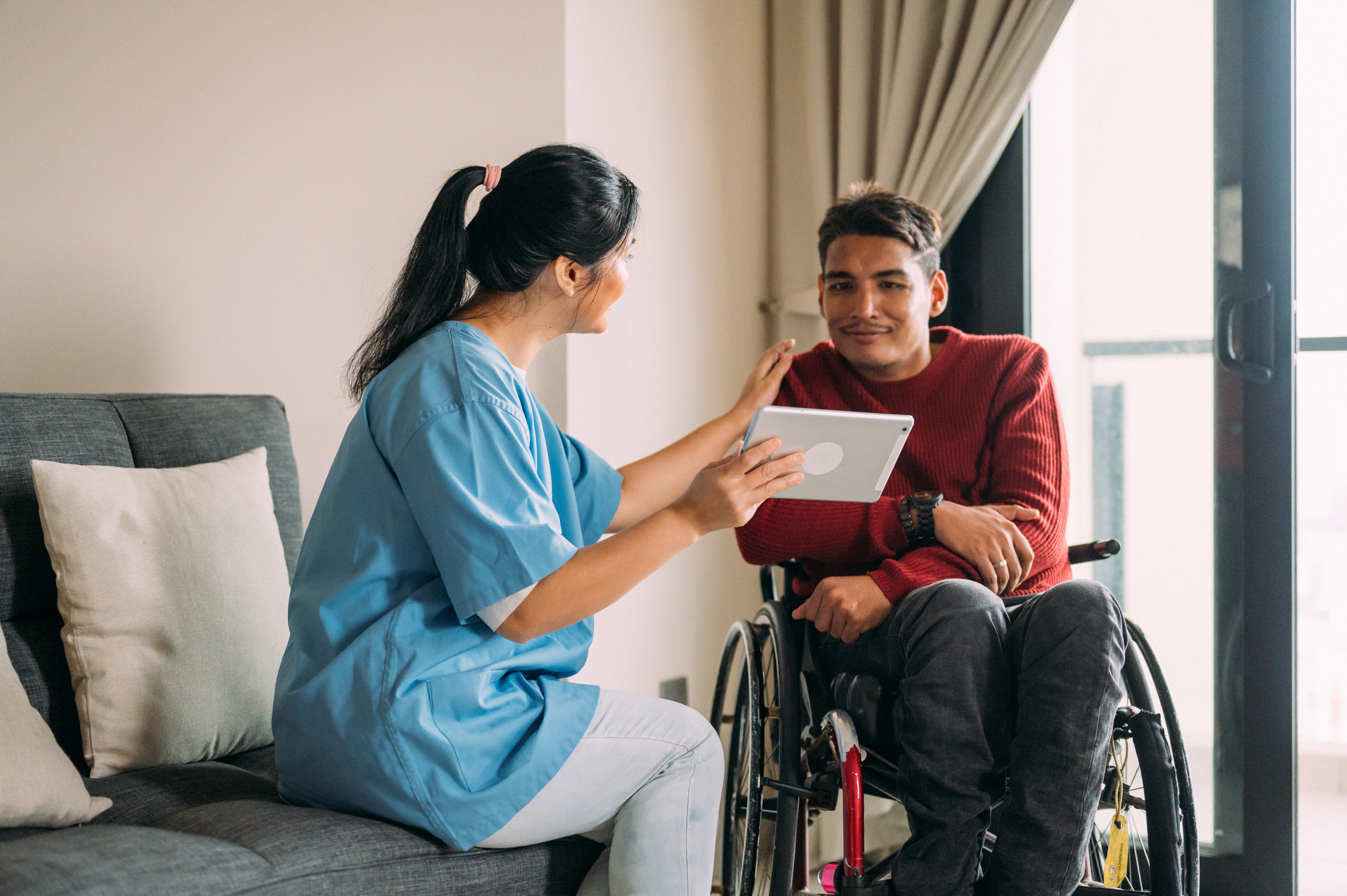 Two women shaking hands and laughing.